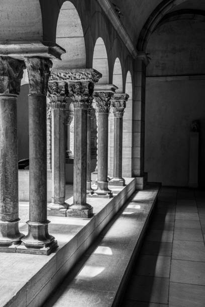 Cloister with areches and columns in NYC NEW YORK CITY, NY, USA - JULY 3RD 2019 - European medieval cloister in Washington heights in Manhattan (NYC) black and white travel travel destinations monk stock pictures, royalty-free photos & images