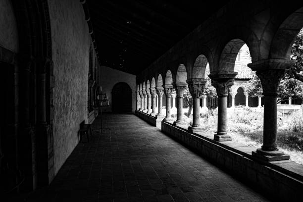 Cloister with areches and columns in NYC NEW YORK CITY, NY, USA - JULY 3RD 2019 - European medieval cloister in Washington heights in Manhattan (NYC) black and white travel travel destinations monk stock pictures, royalty-free photos & images