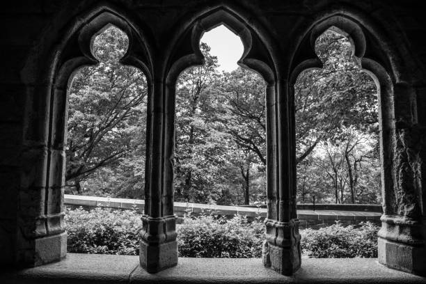 Gothic window to a garden NEW YORK CITY, NY, USA - JULY 3RD 2019 - Window in a Medieval complex in Washington heights in Manhattan (NYC) black and white travel travel destinations monk stock pictures, royalty-free photos & images