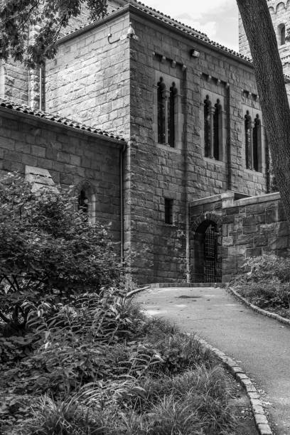 Romanesque and gothic building in NYC NEW YORK CITY, NY, USA - JULY 3RD 2019 - Facade of a Medieval complex in Washington heights in Manhattan (NYC) black and white travel travel destinations monk stock pictures, royalty-free photos & images