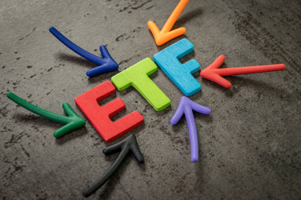 istock ETF, exchange-traded fund an investment fund traded on stock exchanges concept, multi color arrows pointing to the word ETF at the center of black cement chalkboard wall 1170398354