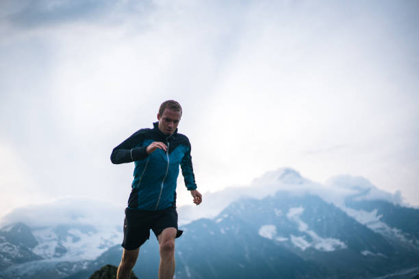 istock Trail runner bounds along mountain meadow in the morning 1170398519