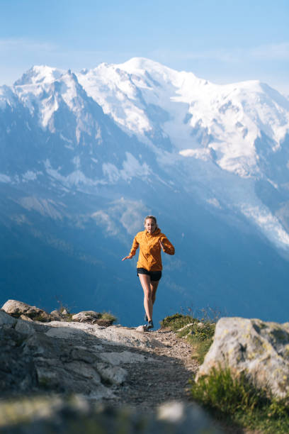 istock Young woman trail runs in mountains 1170398634