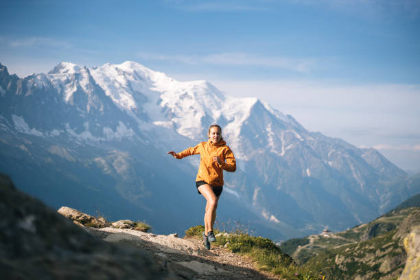 istock Young woman trail runs in mountains 1170398700