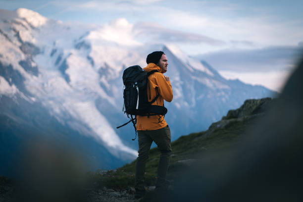 istock Hiker explores alpine meadow at sunrise 1170398755