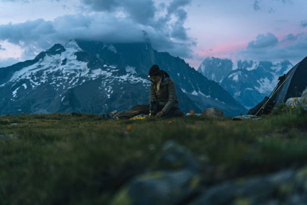istock Hiker prepares meal at campsite with headlamp 1170398848