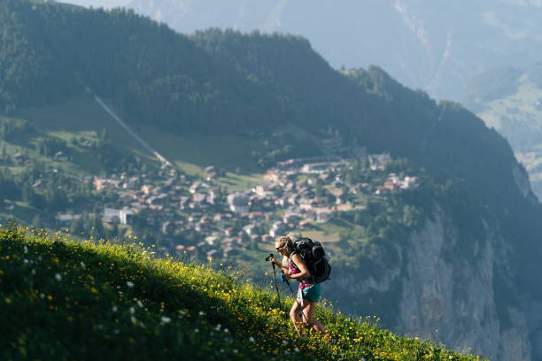 istock Young woman hikes through alpine above valley 1170399372