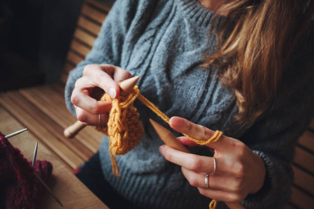 istock Close up on woman's hands knitting 1170400209