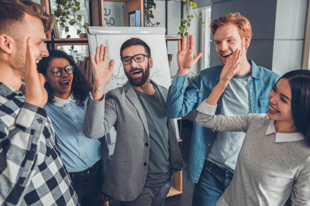 istock Startupers working at office together standing giving high five cheerful 1170400282