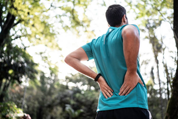 istock Sportsman feeling backache at a park 1170400408