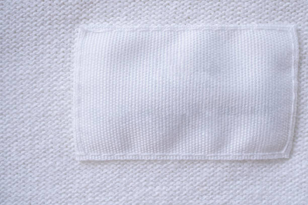 istock Blank white clothes label on new shirt background 1170400890
