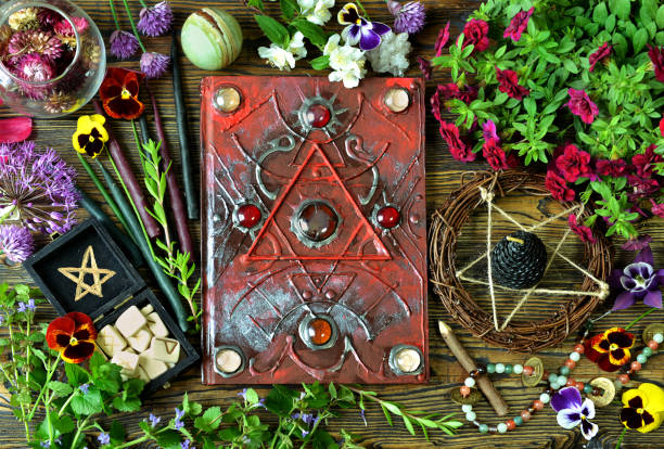 istock Still life with magical book, healing crystals, runes and herbs on witch table. 1170407879