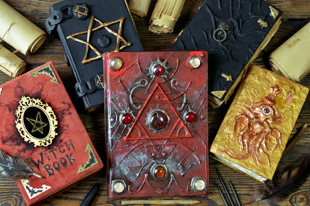 istock Pile of magical evil books with spells on witch table. 1170407931