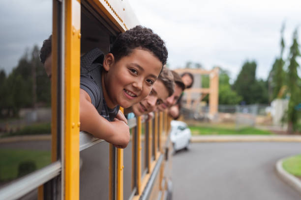istock Portrait of elementary students in school bus 1170409701