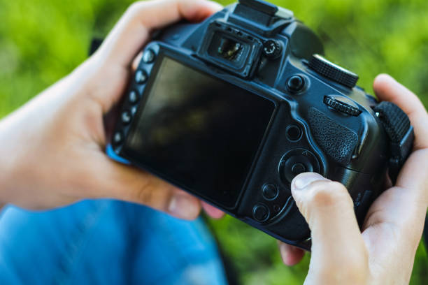 istock Professional woman looking at photo camera 1170409842