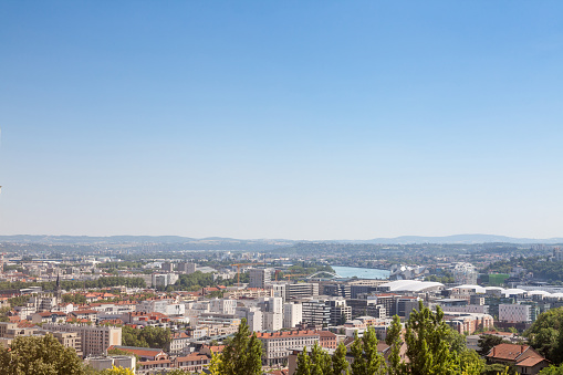 Picture of he landscape of Lyon, France, from above, on the Fourviere hill during a sunny afternoon. The Rhone river and the suburbs of Lyon are visible