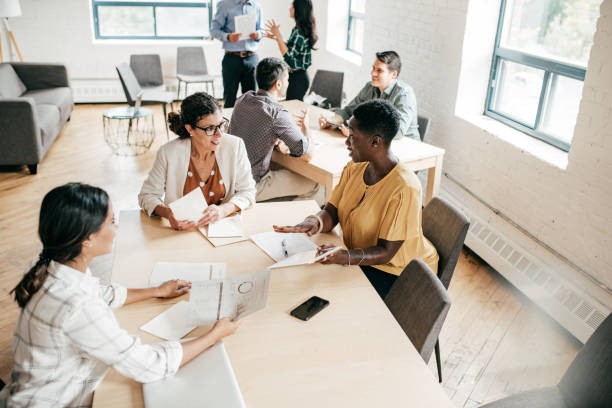 istock Multi-ethnic group negotiating  in a coworking space 1170410105