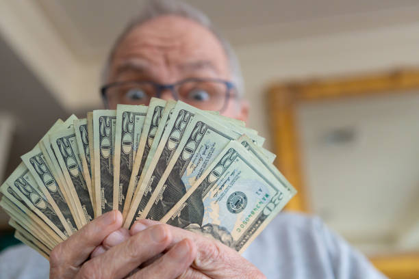 istock Happy senior man with money 1170413071