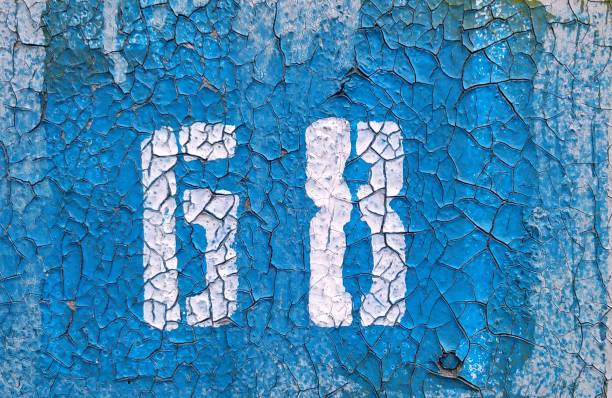 istock The number 68 with white paint on a cracked blue background. Close-up. 1170414015