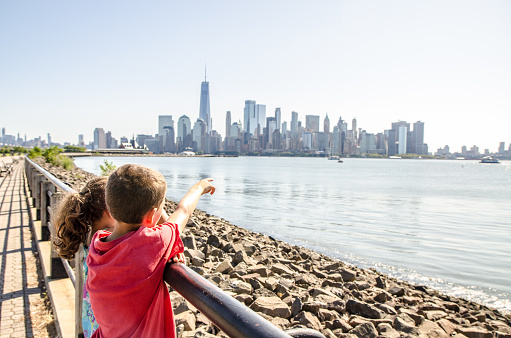Manhattan Skyline and Ellis Island seen from Liberty State Park during summer day