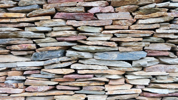 istock Stone wall with cement texture background natural color. Old brown rock stone wall pattern or wallpaper and backdrop for home design. 1170418589