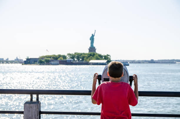 istock Kid looking at Statue of Liberty 1170418697