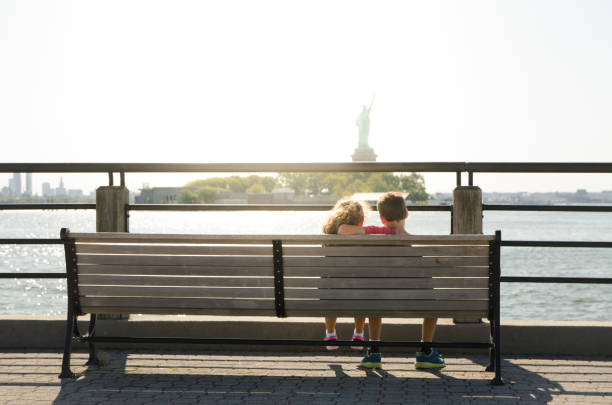 istock Two kids looking at Statue of Liberty 1170419529