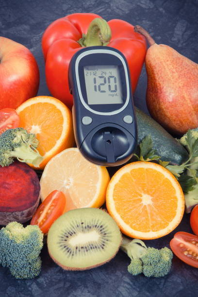 istock Glucometer for checking sugar level with fruits and vegetables containing vitamins, healthy eating for diabetic 1170422875