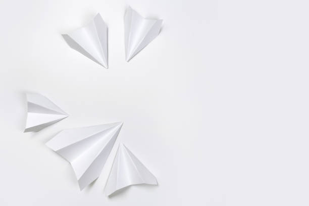 istock white paper airplane on a white paper background 1170424536