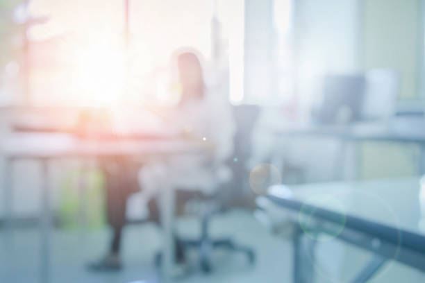 istock Blurred office building working on computer, Business education or school background interior view looking out toward to empty lobby and glass window wall with green tree and fence. 1170425467