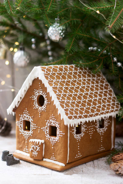 istock Gingerbread house and Christmas trees on a luminous background. Bokeh effect. 1170425708