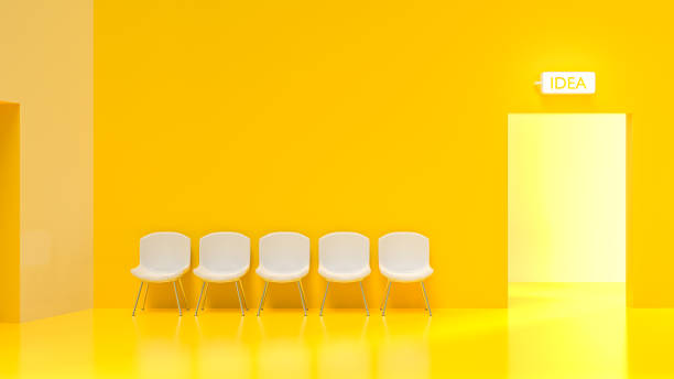 istock Five white chairs in a yellow room with bright light at the door. 1170426415