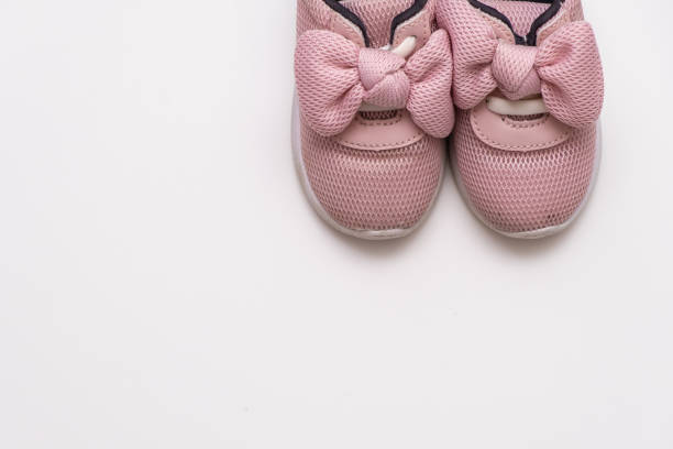 istock On a white background, pink baby sneakers, copy space 1170430072
