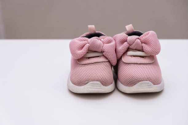 istock On a white background pink baby female sneakers, copy space 1170430141