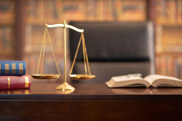 justice scales legal law justice scales and law books on desk in lawyer office. equal arm balance stock pictures, royalty-free photos & images