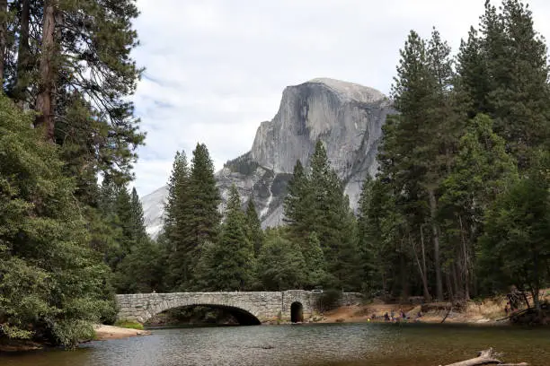 Stoneman Bridge in Yosemite National Park with Half Dome Mountain in the background.