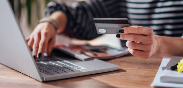 istock Woman shopping online and using credit card 1170444877