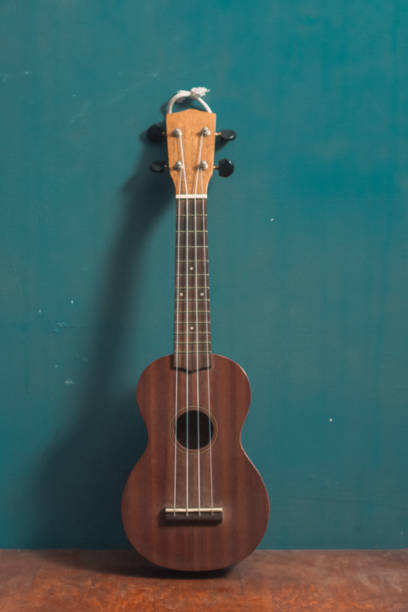istock ukulele in front view on wood with isolated blue background 1170445428