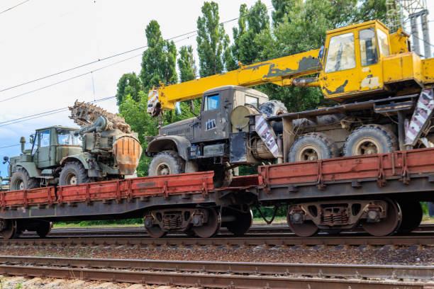 istock Cargo train carrying military vehicles on railway flat wagons 1170446291
