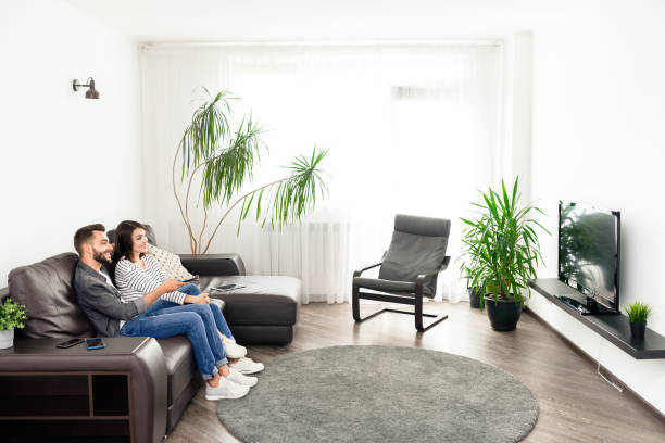 istock Cheerful couple watching tv 1170447955