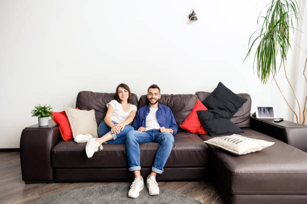 istock Beautiful couple sitting on sofa 1170447984
