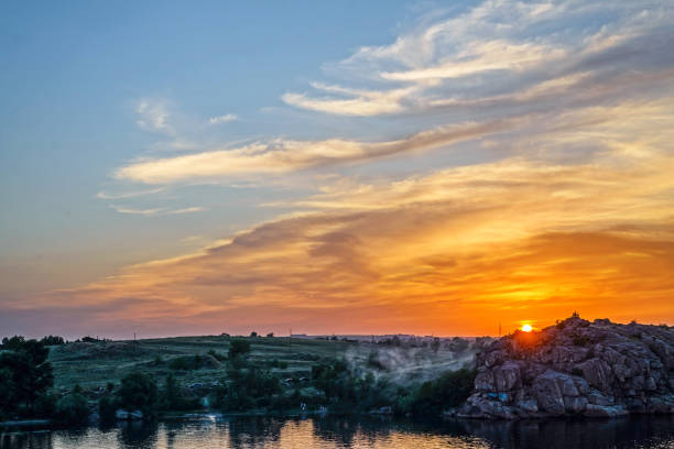 istock Beautiful and bright sunset over the river. 1170449050