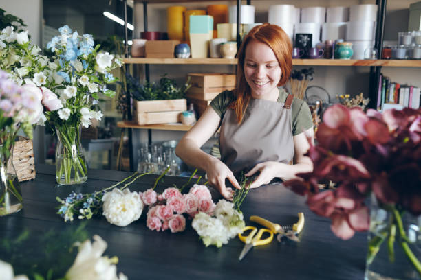 istock Cheerful florist arranging bouquet 1170449679