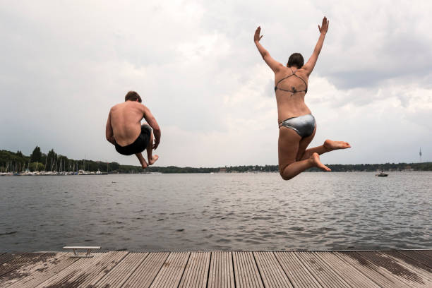 istock Cannonball diving: young adults jump into Wannsee lake 1170452866