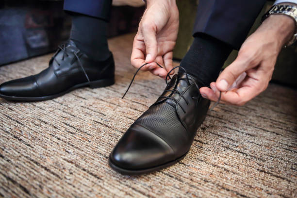 istock Business man knot shoe lace indoor 1170453565