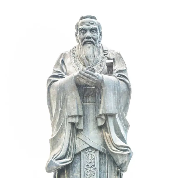 Confucius statue isolated on white background. Located in Jianshui Confucius Temple, Jianshui, Yunnan, China.