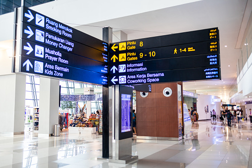 Dual Language Signages at Modern Ngurah Rai International Airport, Bali. Terminal offers excellent shopping experiences while transiting passengers can enjoy refreshments and beverage at food court.