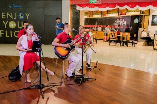 Group of Musicians performing on the Independence Day at Ngurah Rai International Airport Terminal. This airport terminal offers excellent environment to its passing passengers with shopping, entertainment and food establishments.
