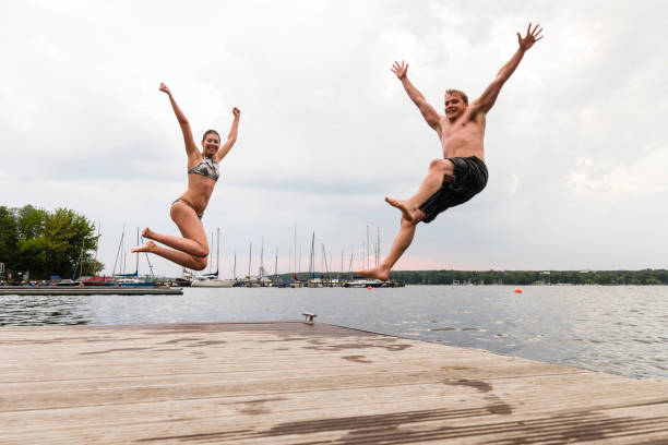 istock taking the plunge: young adults jump into Wannsee lake 1170462313
