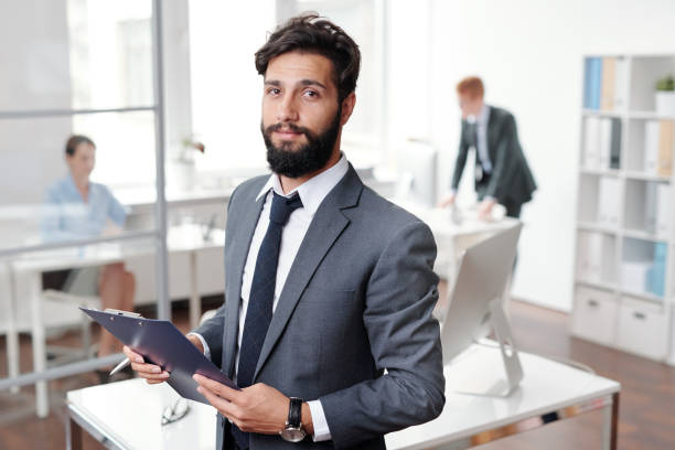 istock Bearded Businessman Posing in Office 1170462958